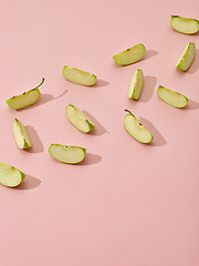 Image showing apple pieces on pink background