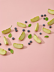 Image showing apple pieces, blueberries and green basil leaves