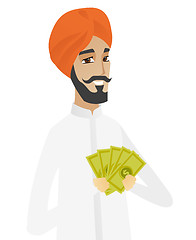 Image showing Happy hindu businessman holding money.