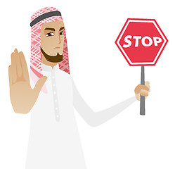 Image showing Muslim businessman holding stop road sign.