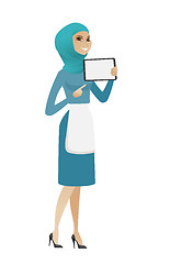 Image showing Young muslim cleaner holding tablet computer.