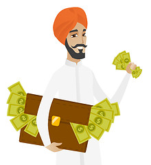 Image showing Hindu businessman with briefcase full of money.