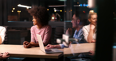 Image showing Multiethnic startup business team in night office