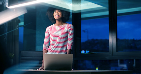 Image showing black businesswoman using a laptop in night startup office