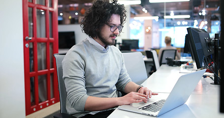 Image showing businessman working using a laptop in startup office