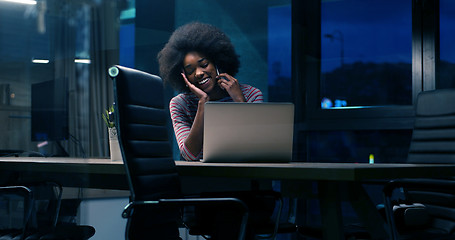 Image showing black businesswoman using a laptop in night startup office