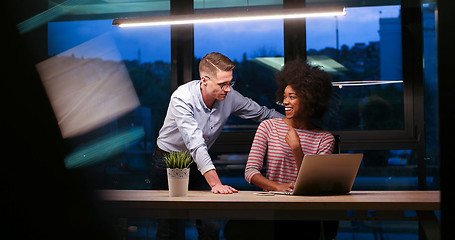 Image showing Multiethnic startup business team in night office