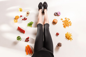 Image showing Athletic girl with healthy food on floor