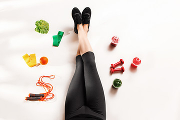 Image showing Athletic girl with healthy food on floor