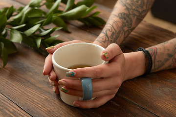 Image showing Female hands holding coffee cup