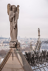 Image showing Angel is playing an horn