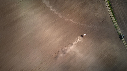 Image showing Aerial view the tractor plows the spring field.spring season of agricultural works at farmlands. Drone photograph