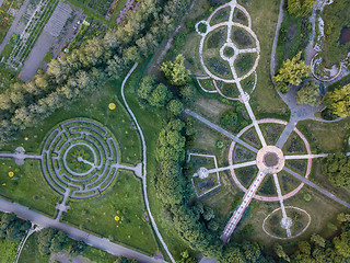 Image showing Birds eye view from the drone to a Garden labyrinth and park alleys of the round form in the park.