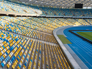 Image showing KYIV, UKRAINE - July 19, 2018. The inside part of the Olympic sports complex with a football field, stands and treadmills.