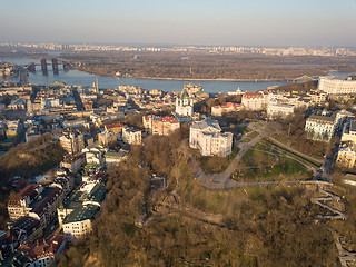 Image showing A bird\'s eye view, aerial view shooting from drone of the Podol district, oldest historical center of Kiev, the Dnieper River and the left bank of Dnieper in the city of Kiev, Ukraine.