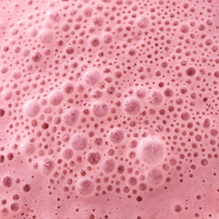 Image showing Macro photo of berry healthy pink smoothie with bubbles. Food background. Tip view