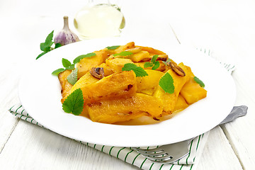 Image showing Pumpkin with garlic in plate on white board