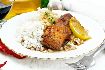 Image showing Salmon with sauce in plate on wooden board