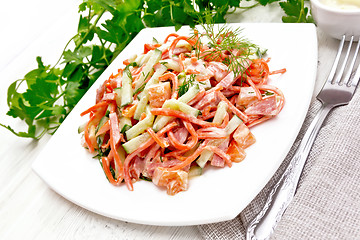 Image showing Salad of sausage and spicy carrots with mayonnaise on light boar