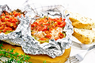 Image showing Salmon with vegetables in foil on white board