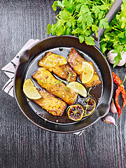 Image showing Salmon with sauce in pan on black board top