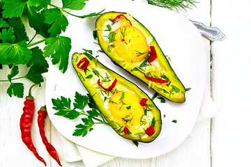 Image showing Scrambled eggs with peppers in avocado on board top