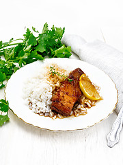 Image showing Salmon with sauce and rice in plate on board