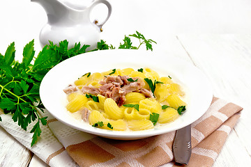 Image showing Soup creamy of chicken and pasta in plate on towel