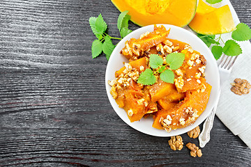 Image showing Pumpkin with nuts and honey on board top