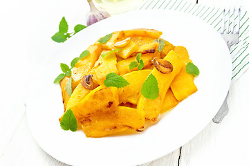 Image showing Pumpkin with garlic in plate on board