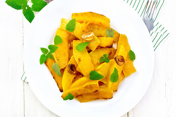 Image showing Pumpkin with garlic in plate on board top