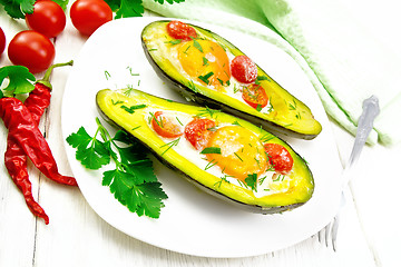 Image showing Scrambled eggs with tomatoes in avocado on white board