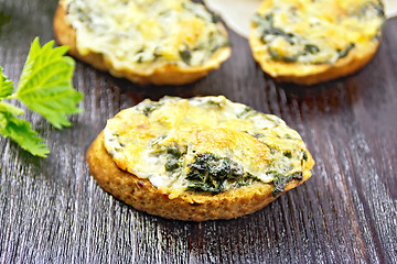 Image showing Sandwich of nettle and cheese on dark wooden board