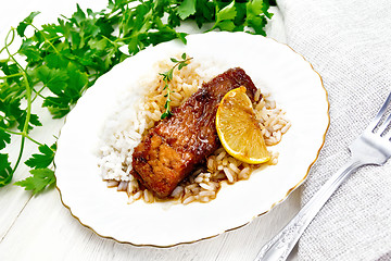 Image showing Salmon with sauce and rice in plate on light board