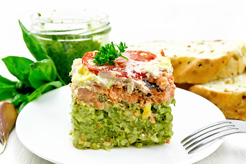 Image showing Casserole of salmon and rice in plate on board