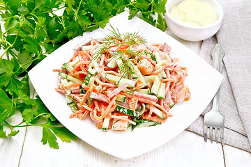 Image showing Salad of sausage and spicy carrots with mayonnaise on light tabl