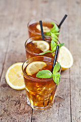 Image showing Traditional iced tea with lemon, mint leaves and ice cubes in th