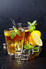 Image showing Two glasses with cold traditional iced tea with lemon, mint leav