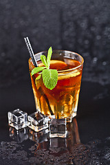 Image showing Traditional fresh iced tea with lemon, mint leaves and ice cubes