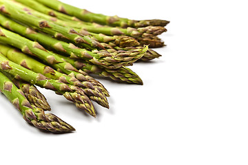 Image showing Bunch of fresh raw garden asparagus closeup on white background.