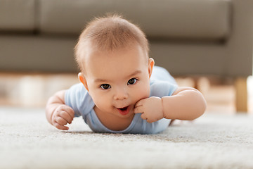 Image showing sweet little asian baby boy lying on floor at home