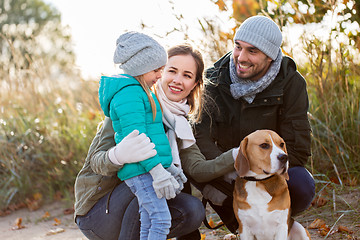 Image showing happy family with beagle dog outdoors in autumn