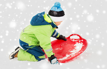 Image showing happy boy with snow saucer sled in winter