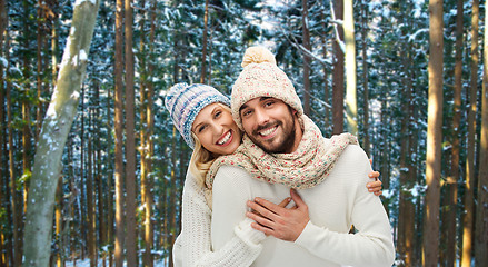 Image showing couple hugging over winter forest background