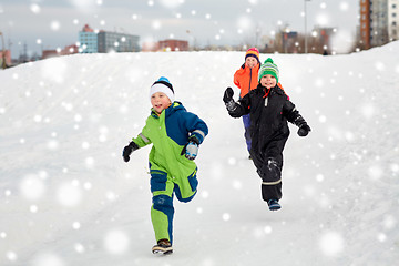 Image showing happy little kids playing outdoors in winter