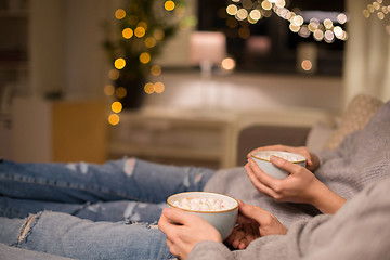 Image showing close up of couple drinking hot chocolate at home