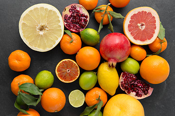 Image showing close up of citrus fruits on stone table