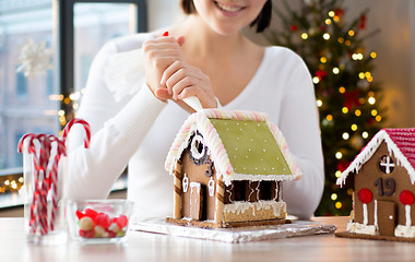 Image showing woman making gingerbread houses on christmas