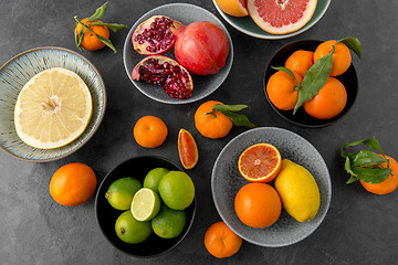 Image showing close up of citrus in bowls fruits on stone table