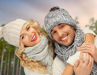 Image showing couple hugging over winter forest background